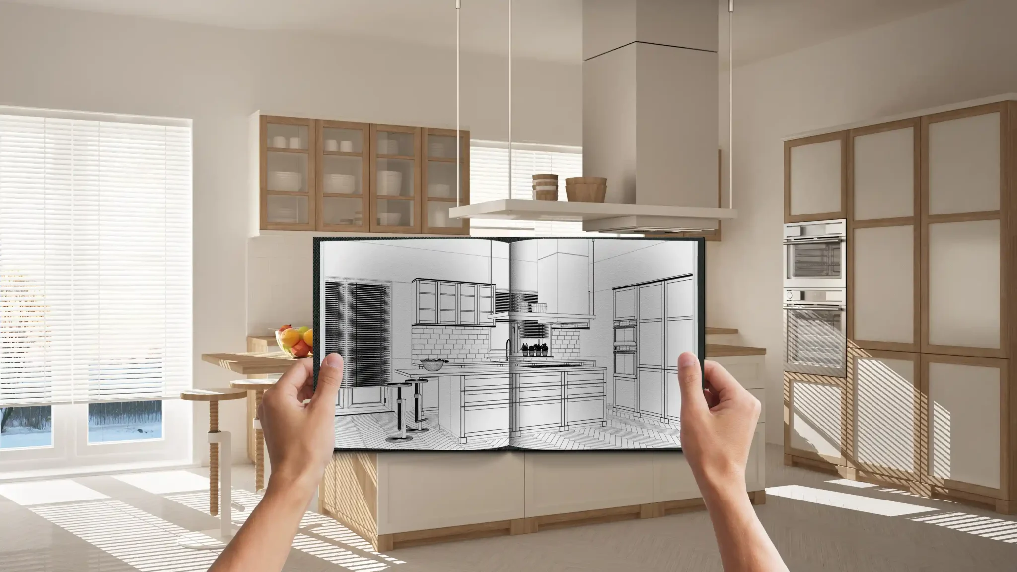 Hands holding a kitchen drawing in front of the finished cabinetry it was made from
